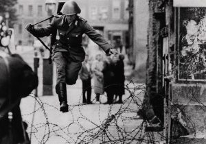 Peter Leibing, "Conrad Schumann Jumping a Barbed Wire Fence at the Berlin Wall", August 1961, silver gelatin print on glossy fibre paper, printed by May 7, 1969, 24,5 (25,7) x 34,7 (35,8), © Peter Leibing, courtesy Daniel Blau, Munich