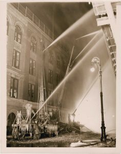 Weegee (1899-1968), "Firemen Directing Water on Fire ", c. 1940, silver gelatin print on glossy fibre paper, printed by January 23, 1940, 21,5 (22,9) x 16,3 (18,0) cm