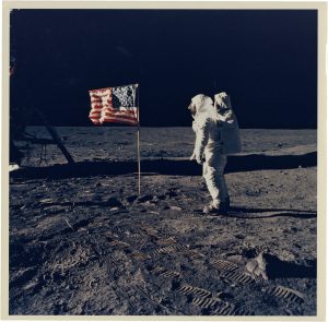 NASA · Apollo XI · Neil Armstrong, "Aldrin Standing on the Lunar Surface Saluting the American Flag", July 20, 1969, vintage color print on matte transitional fibre-PE paper, printed in 1969, 19,3 (20,2) x 19,3 (20,4) cm, © NASA, courtesy Daniel Blau, Munich